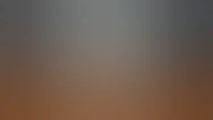 Photograph shows Georges Seurat’s large painting "A Sunday on La Grande Jatte—1884" hanging on a blue-gray wall between two open doorways to other galleries wearing a flat, wide, sharp-cornered white frame.