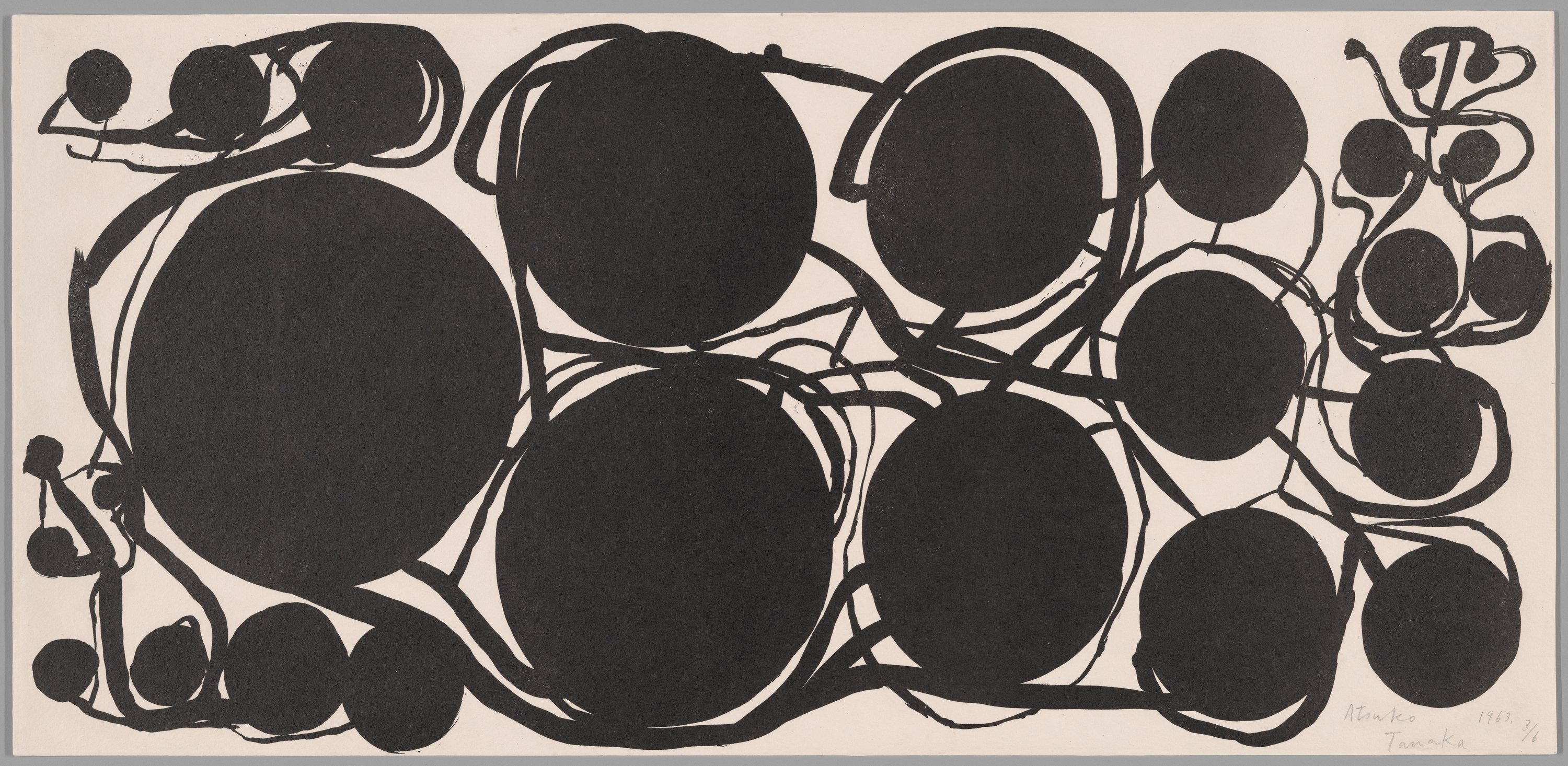 A black ink drawing on white paper shows large black circles linked by looping lines, with three oversized circles at left and center, medium circles scattered across center and right, and smaller clustered circles at top right and along the edges.
