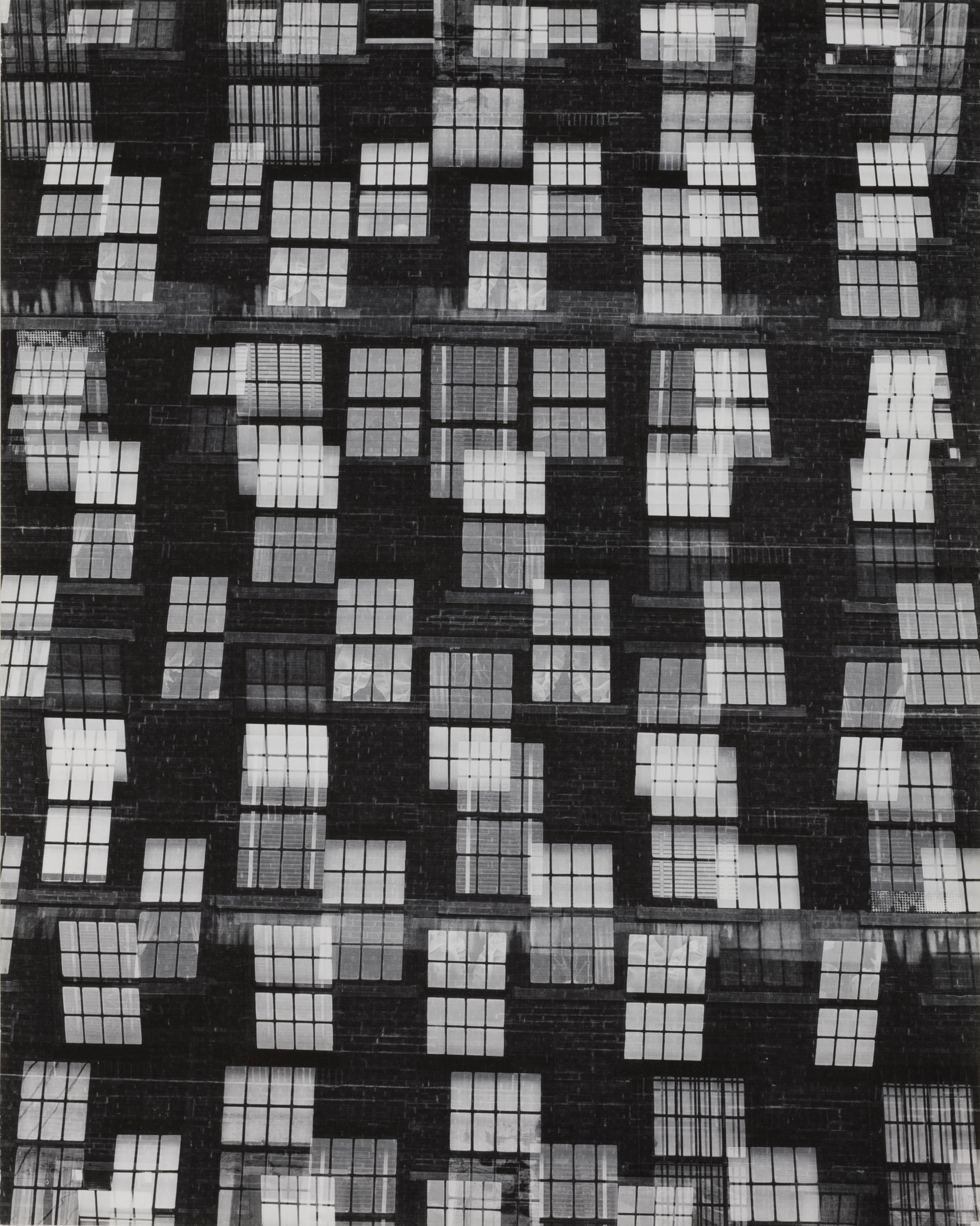 A photographic print of architectural window features superimposed repetitively on one another, creating an abstracted effect