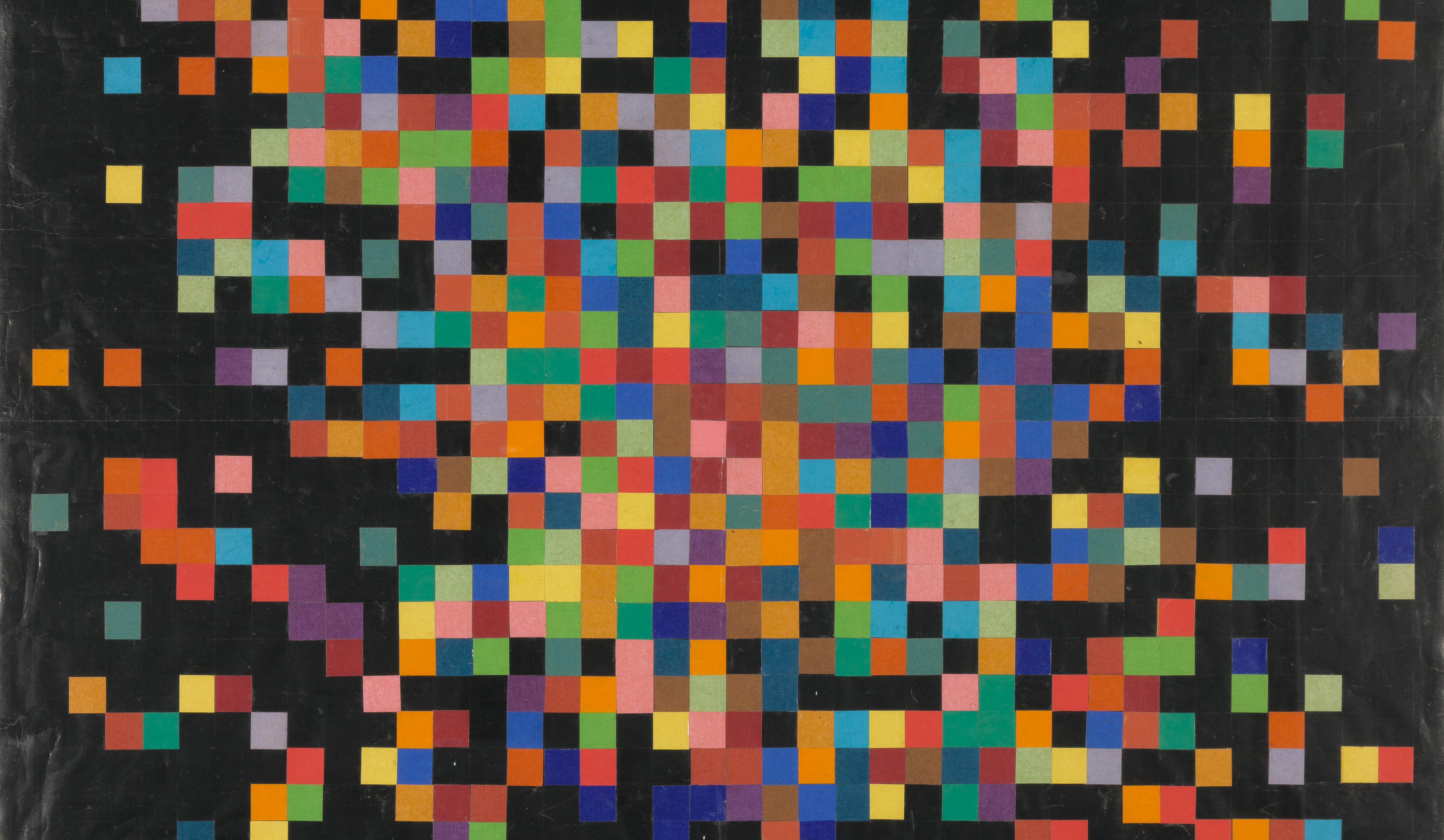 An artwork featuring many dozens of colored squares arranged on a black background, close together in a grid at center and more diffusely toward the edges.