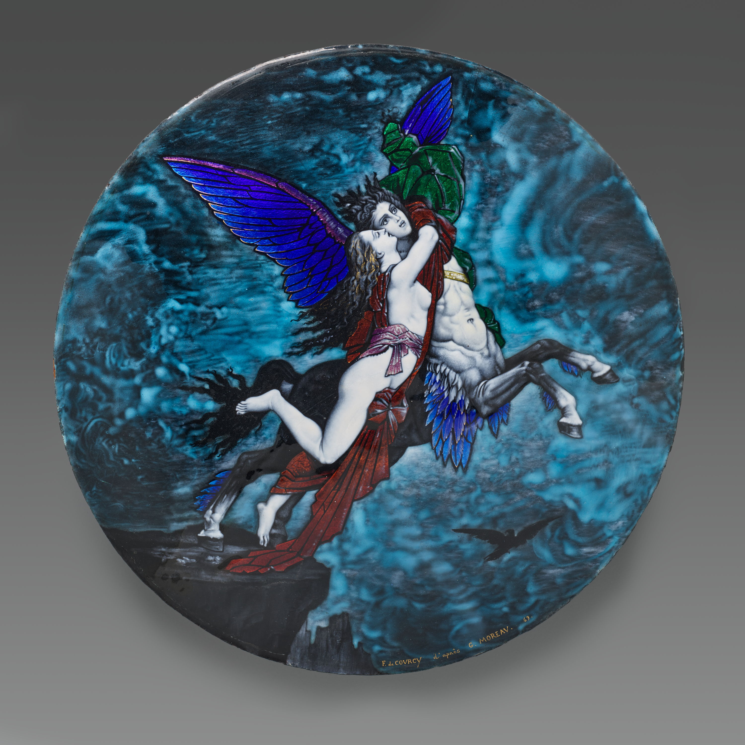A decorative plate shows a blue-winged figure with the white body of a horse and the head of a man flying off a cliff's edge. A mostly nude woman clings onto the figure by the neck, red fabric in the wind. The overall color of the plate is a cloudy swirl of deep teal blue.