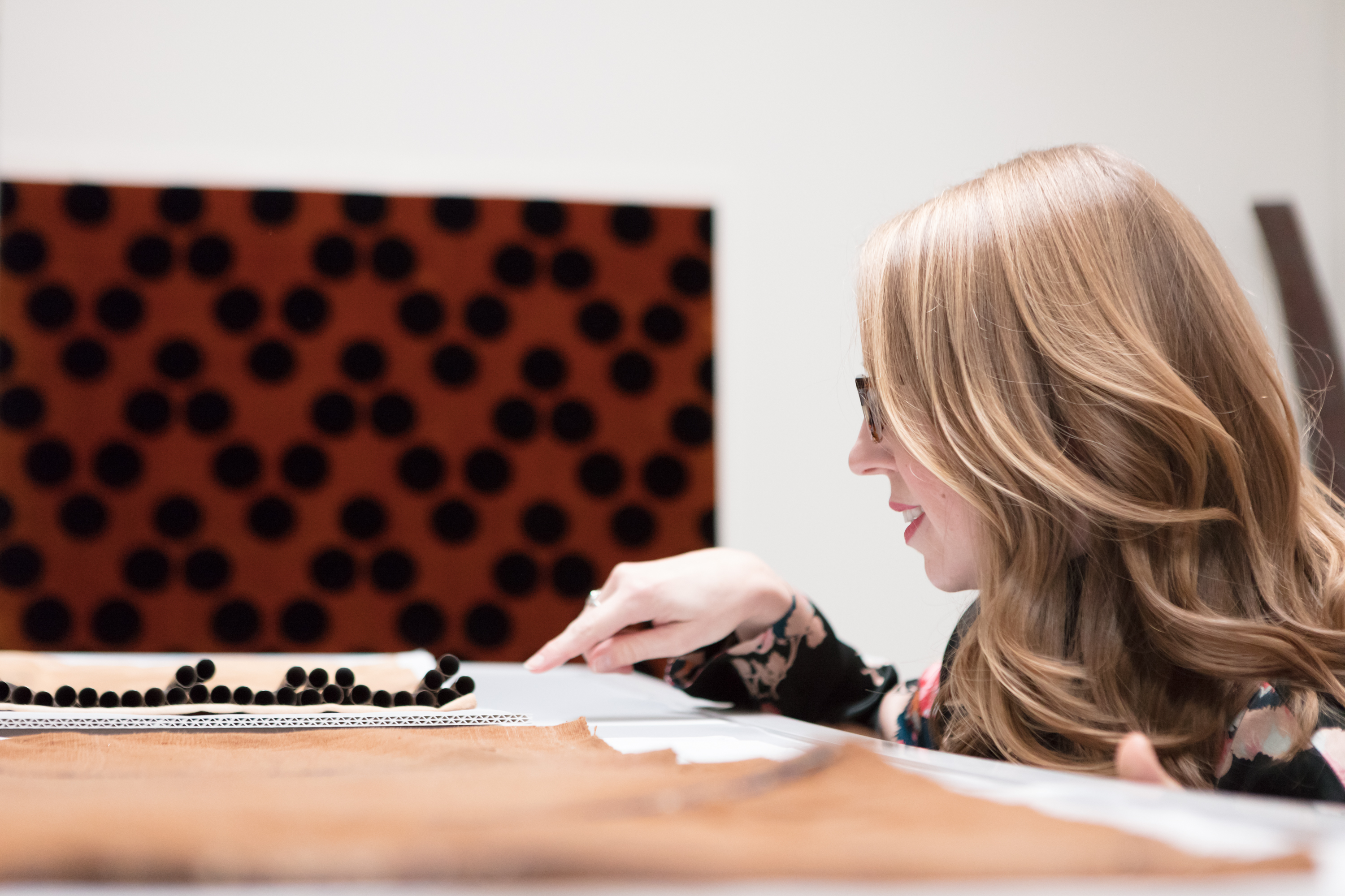 Curator Erica Warren examines a textile