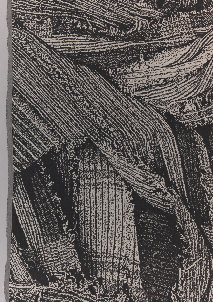 Abstract weaving in black and white of striped fabric scraps piled upon each other.