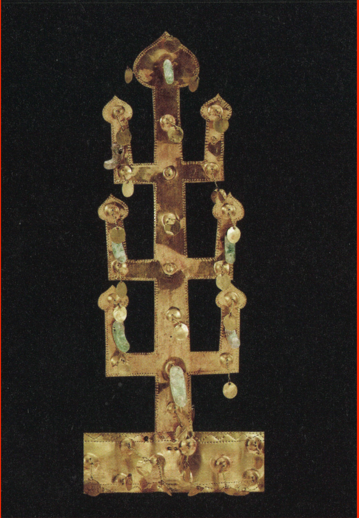 Photo shows one of the vertical elements of the gold crown. From a central trunk three branches on each side extend horizontally and then upright at a 90-degree angle. Beads and small gold discs hang from all parts of the tree shape.