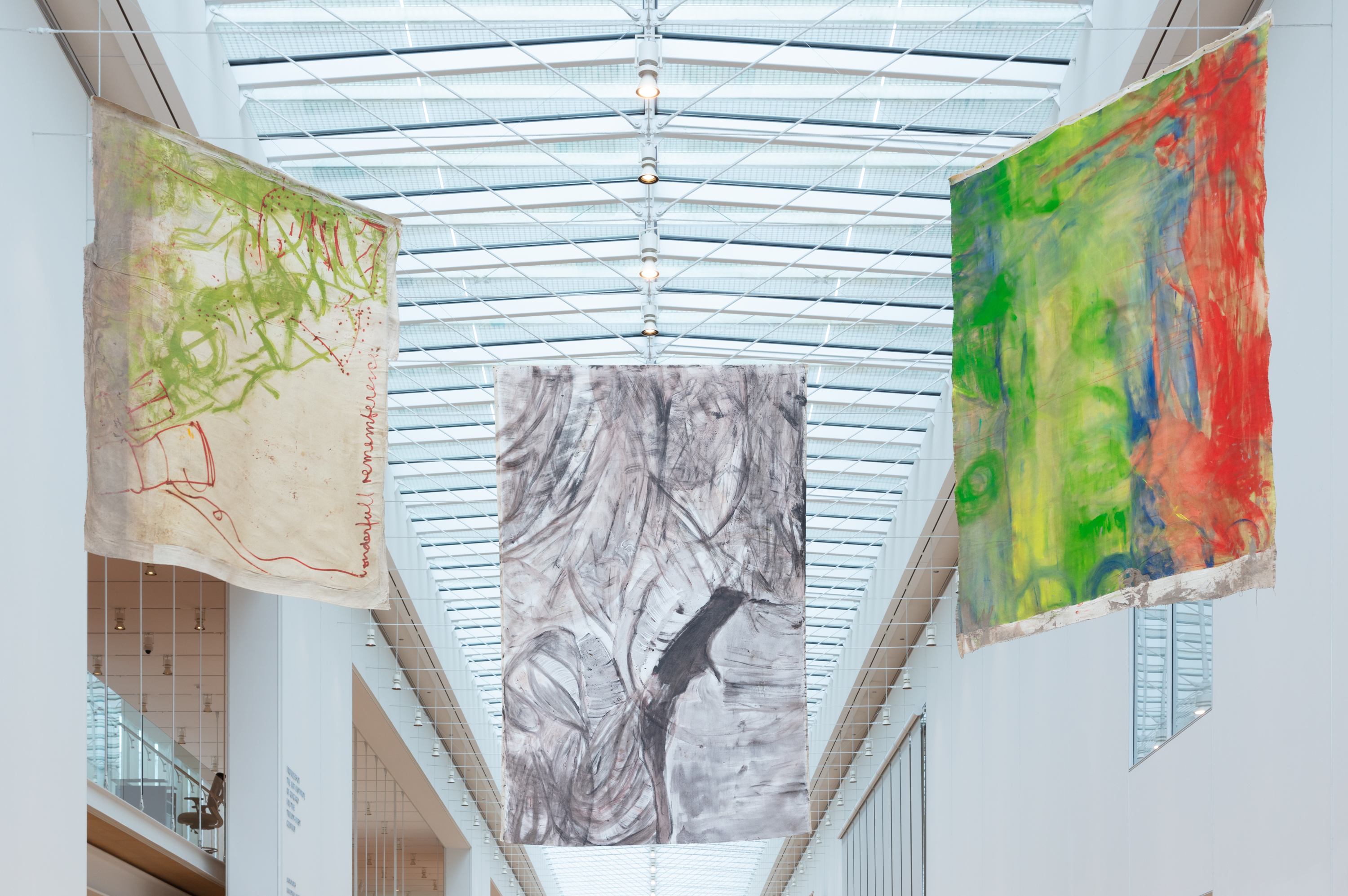 Three paintings on unstretched canvas hang from the ceiling in the museum's Griffin Court.