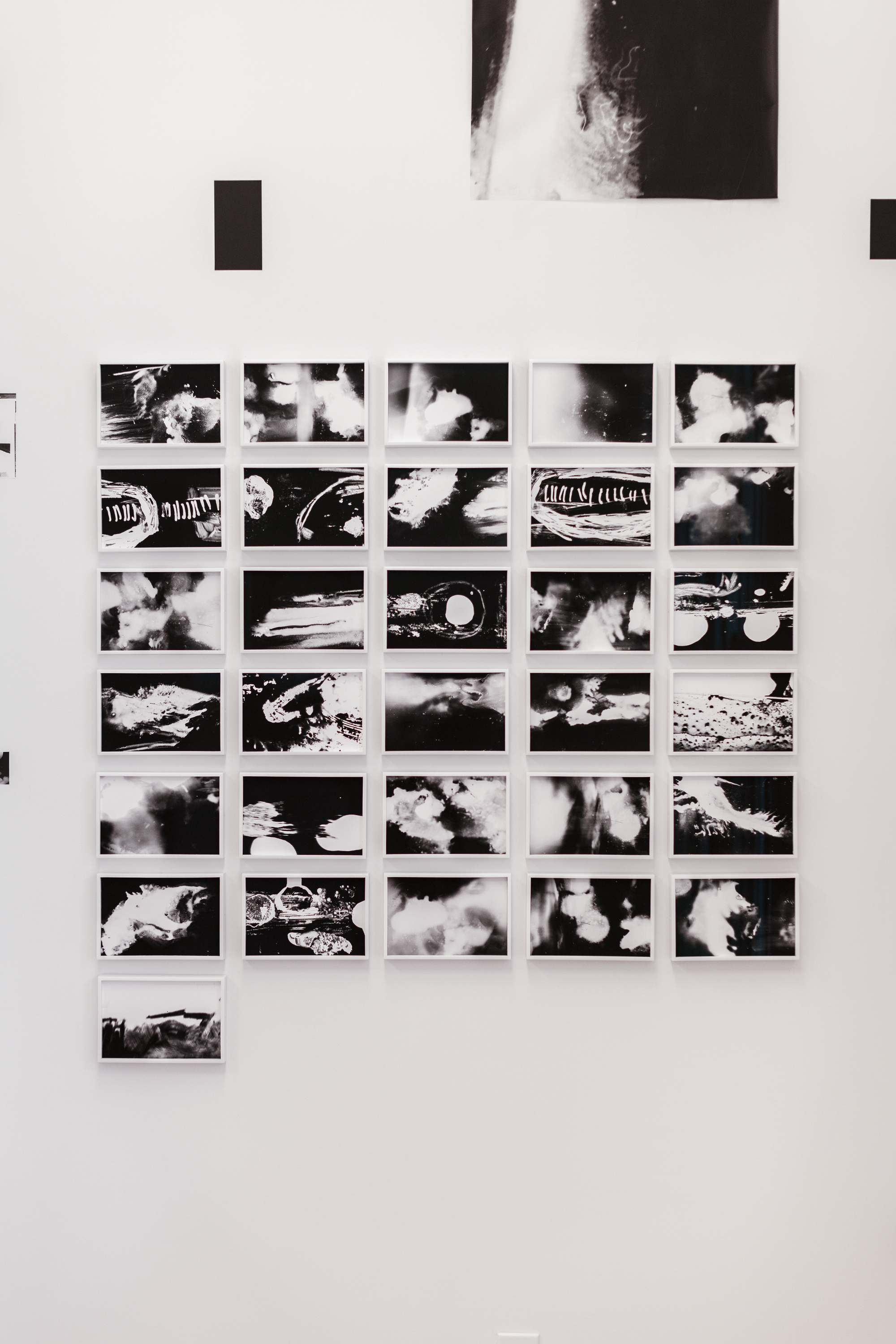 A grid of 31 abstract black-and-white images in white frames. One image sits below the 5 X6 grid in its own row in the leftmost corner.