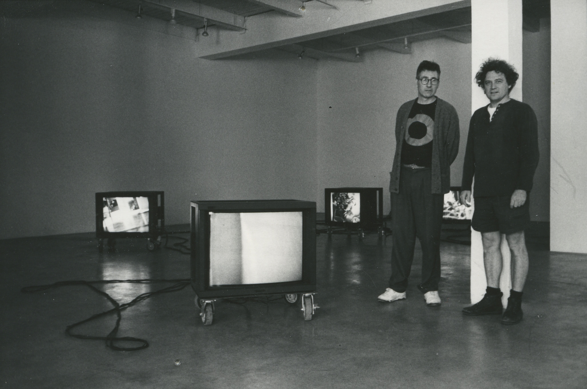 Postcard photo of Donald Young and Eduardo Calderon in Donald Young Gallery, 1996