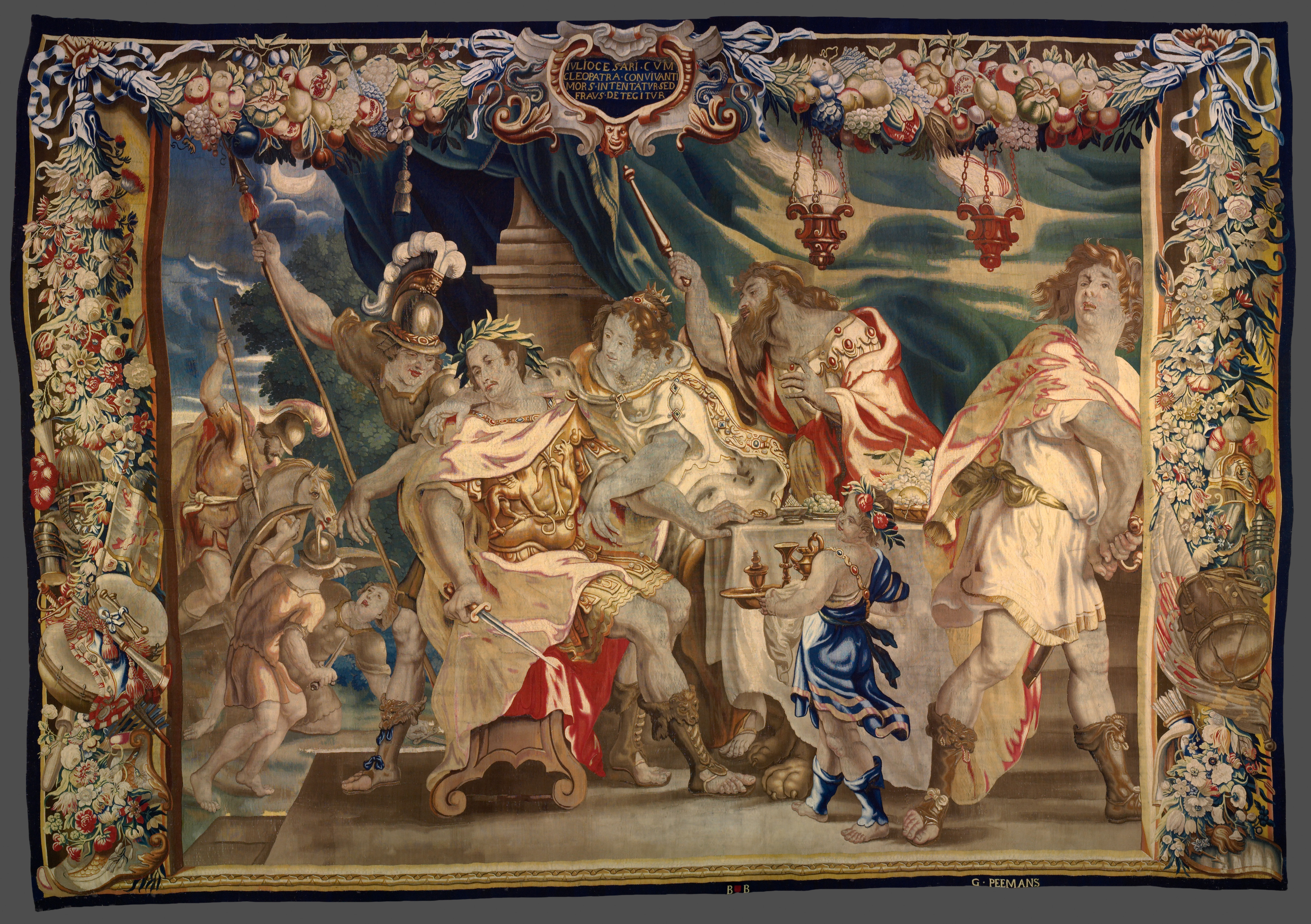 A large tapestry with an ornate border featuring six people congregated around a table.