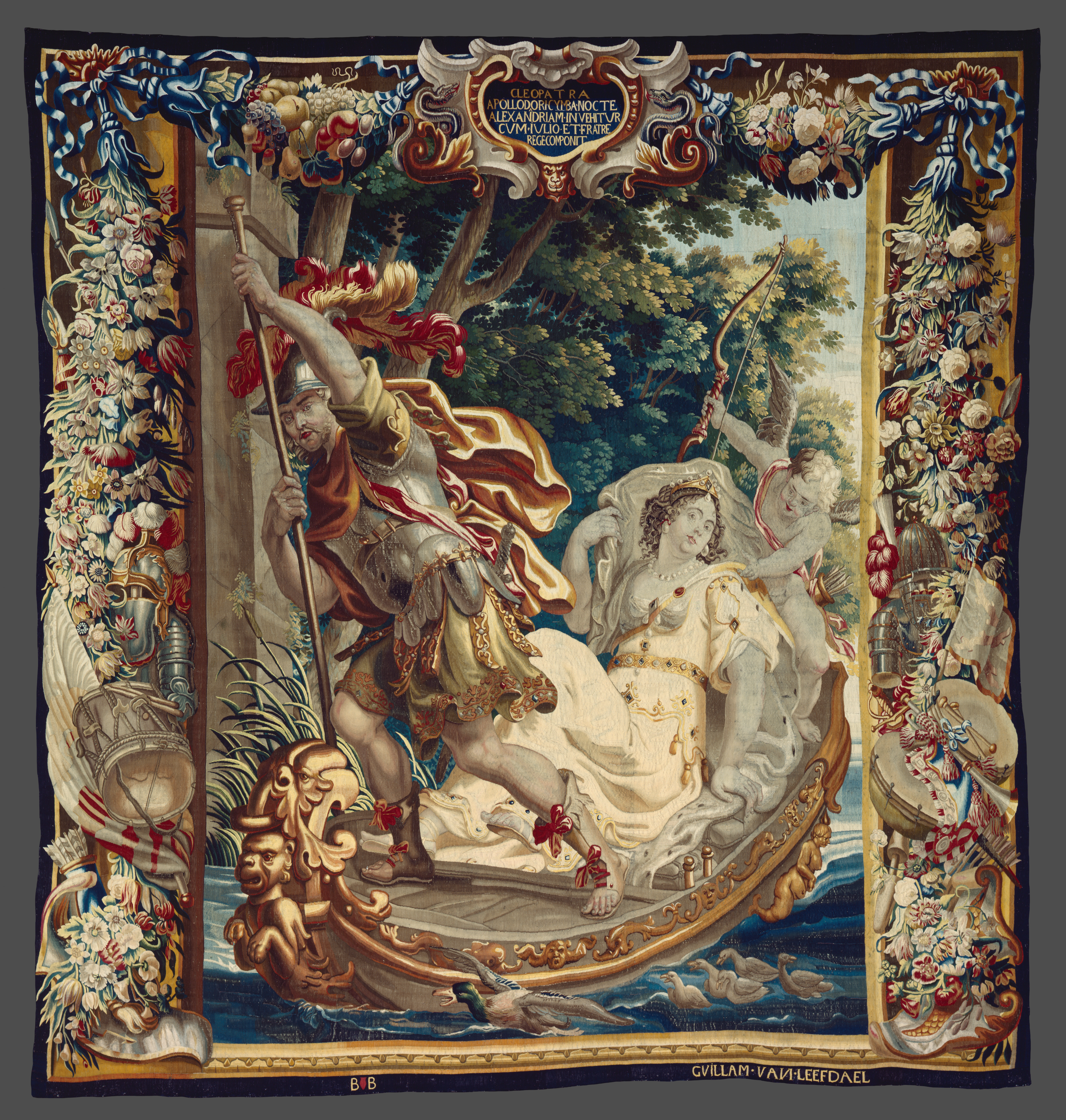 A large tapestry with an ornate border featuring a man and a woman in a boat.
