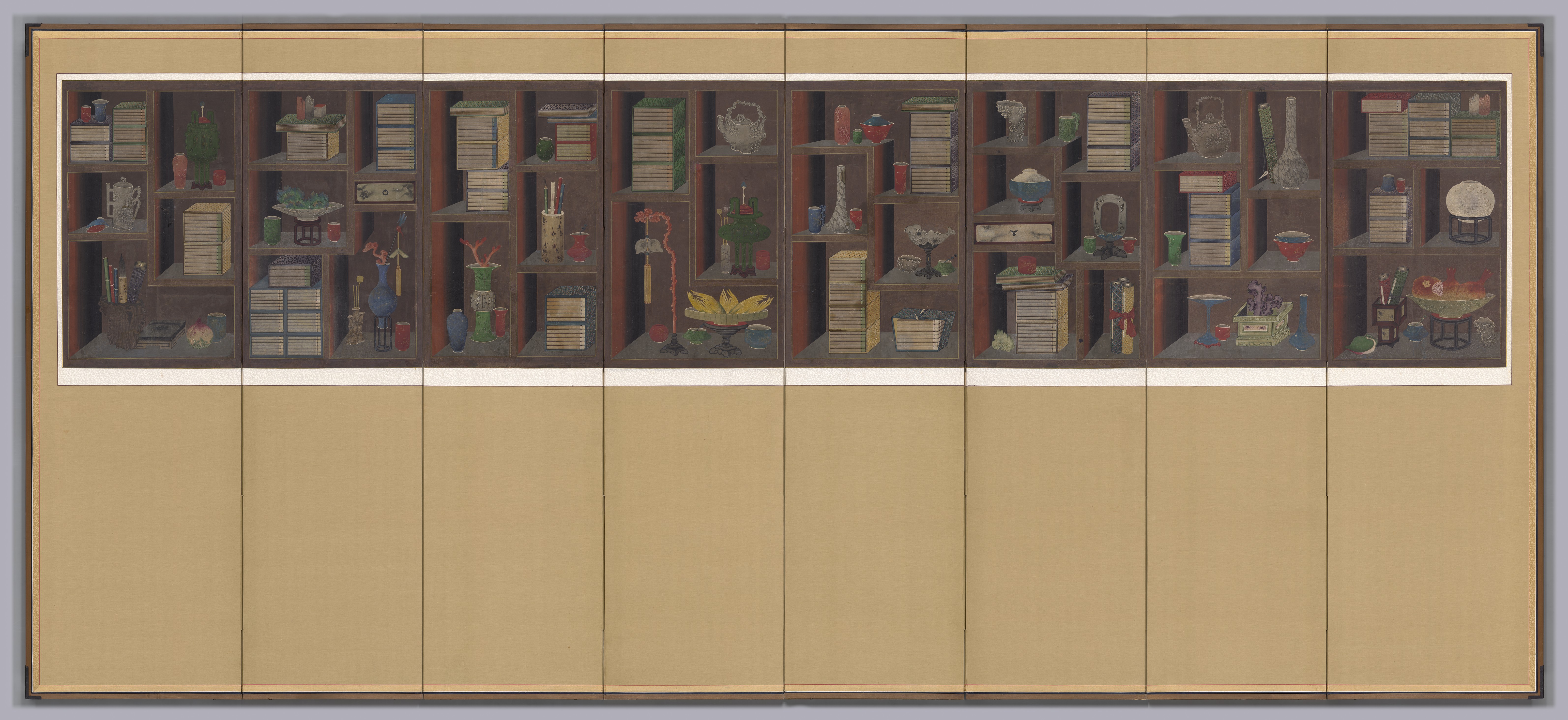 A painted folding screen shows a long band of brown shelves at top filled with stacked books and small vases, bowls, flowers, and brushes; at left and center books dominate, while at right more varied jars and a round white object sit; the lower panels are plain tan.