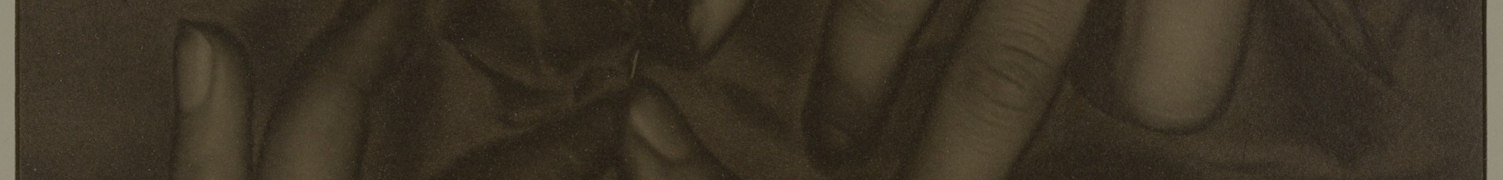 Black and white detail image of hands laid over cloth, 1949.745