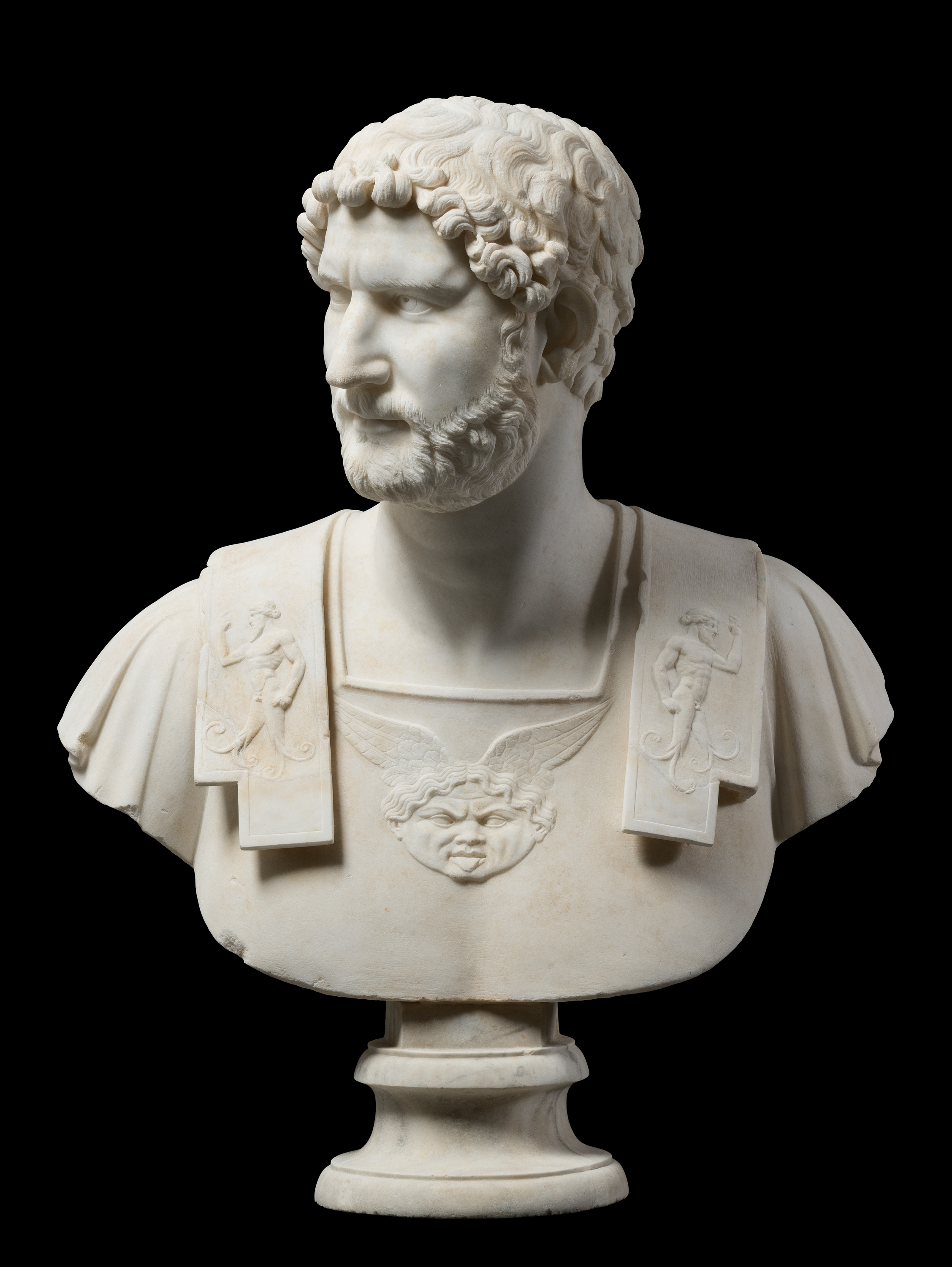 Marble bust of an armored Emperor Hadrian looking towards his right shoulder.