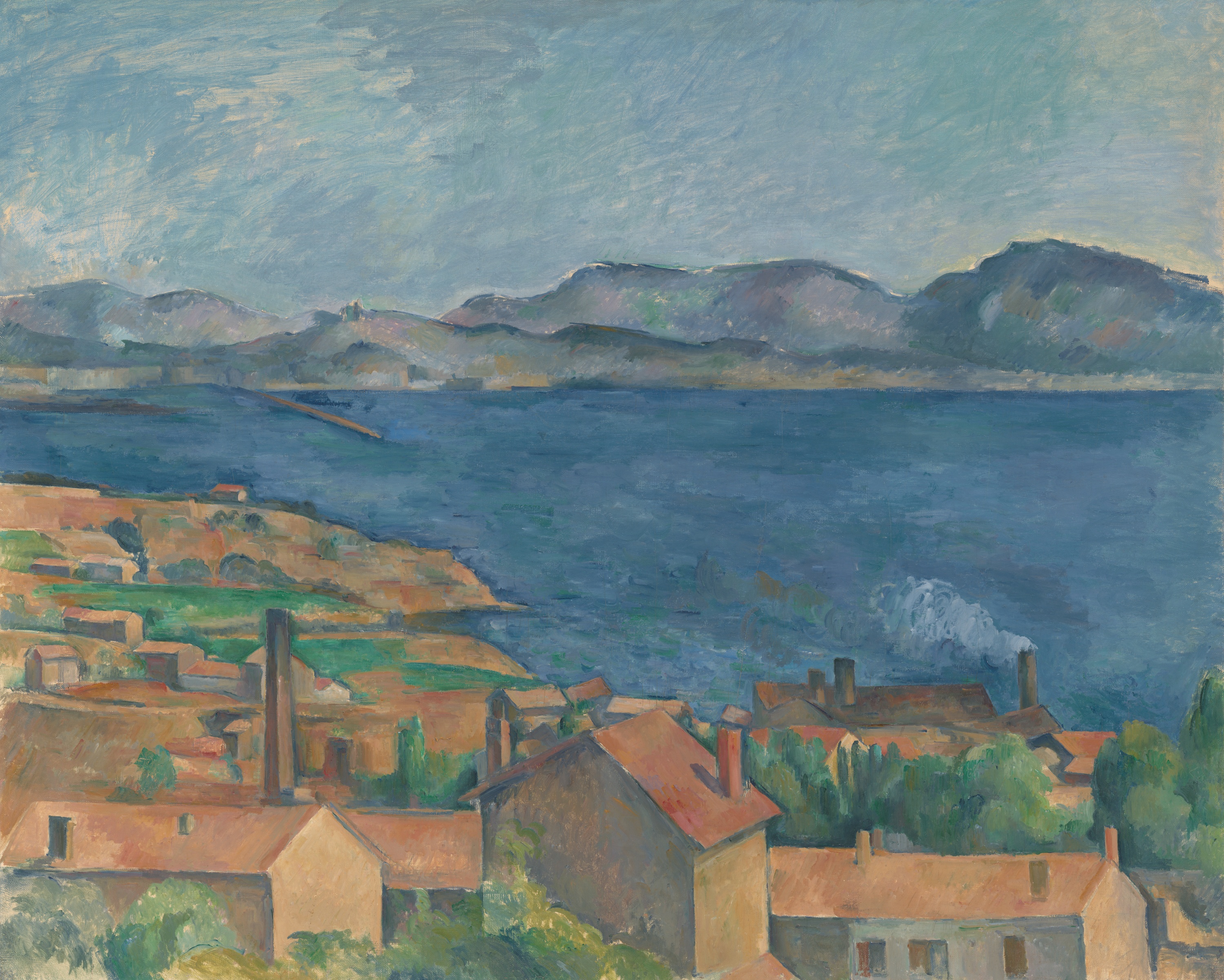 Top section shows a pale blue sky over a line of bluish‑purple hills. Across the middle, a wide dark blue body of water stretches left to right, with a long thin strip of land near center‑left and a light gray plume of smoke rising near the right side. In the foreground, clustered houses with orange‑red roofs and beige walls sit among green trees, with several dark chimneys; buildings are larger at the bottom and become smaller toward the shore.