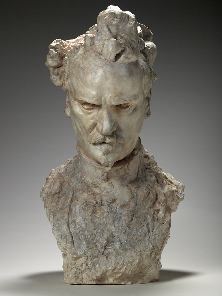 A rough, textured head-and-shoulders form stands upright, with an irregular rounded top and bulbous protrusions on the left and right. Moving downward, the form widens into thick shoulders and a broad torso, its surface marked by deep creases and ridges. Colors are light tan, beige, and gray with darker brown accents in recessed areas.