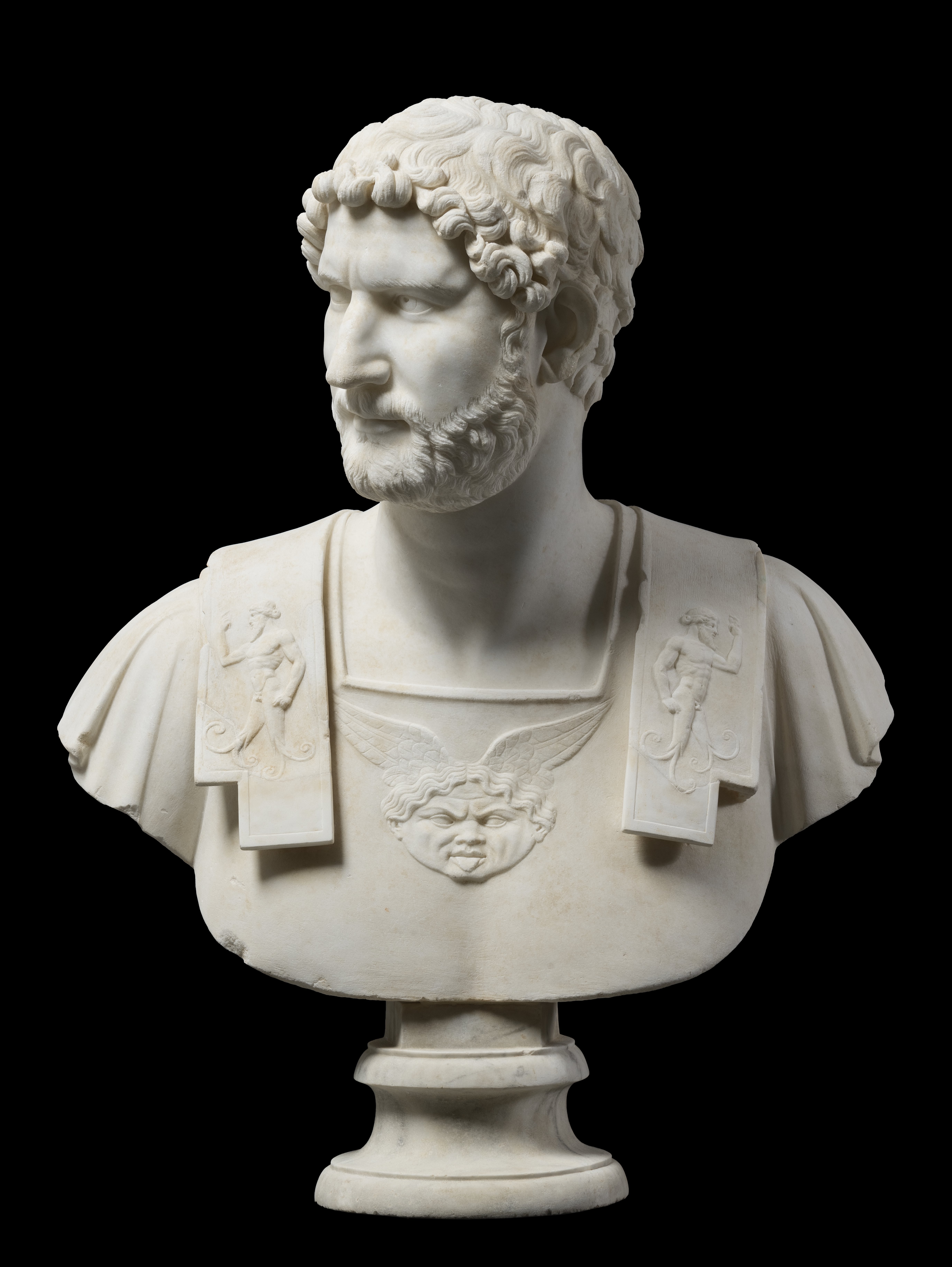 Marble bust of an armored Emperor Hadrian looking towards his right shoulder.