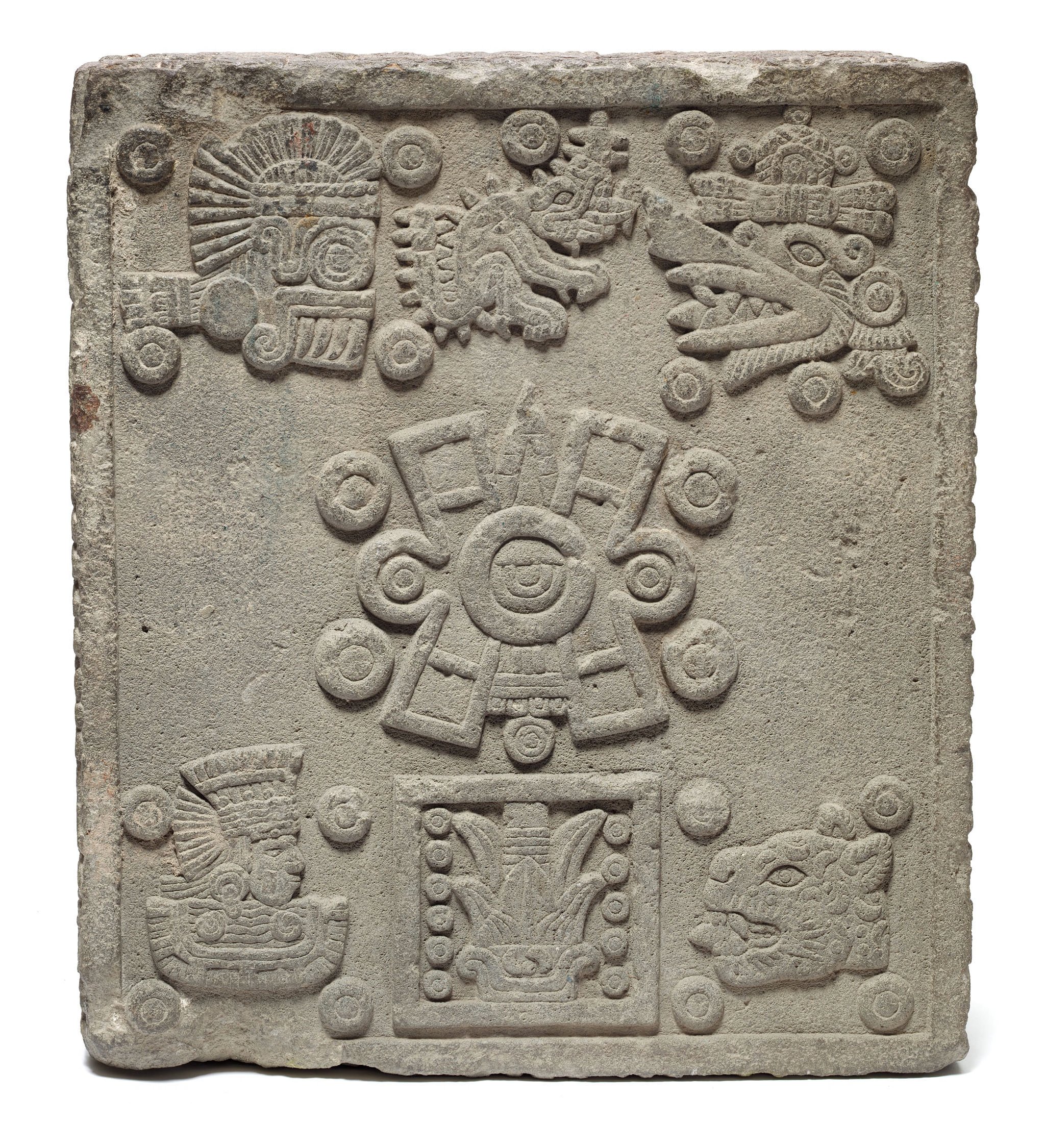 A carved stone tablet with graphic and figurative details.