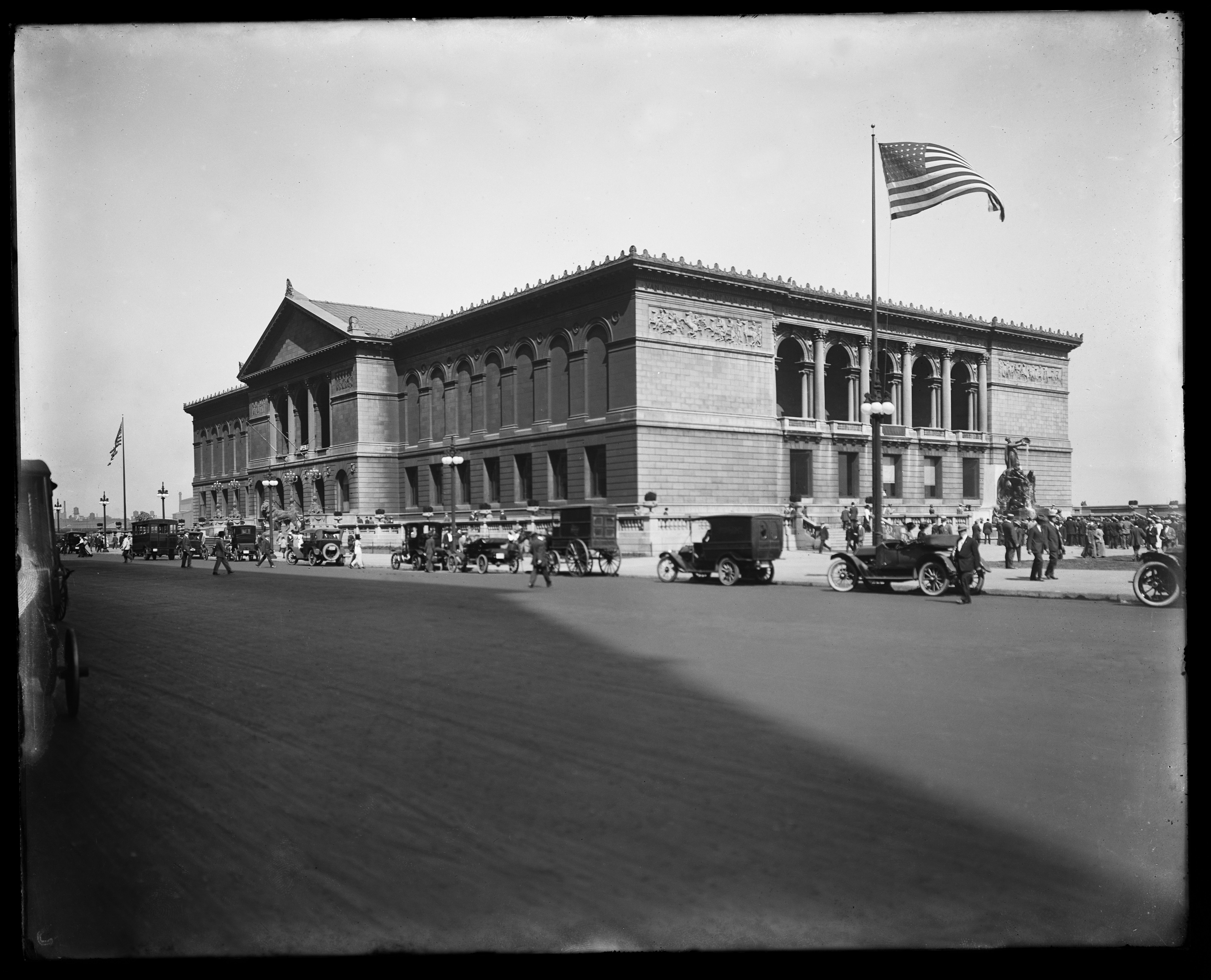 Archival image of an American flag raised in front of the Art Institute of Chicago Michigan Ave. entrace