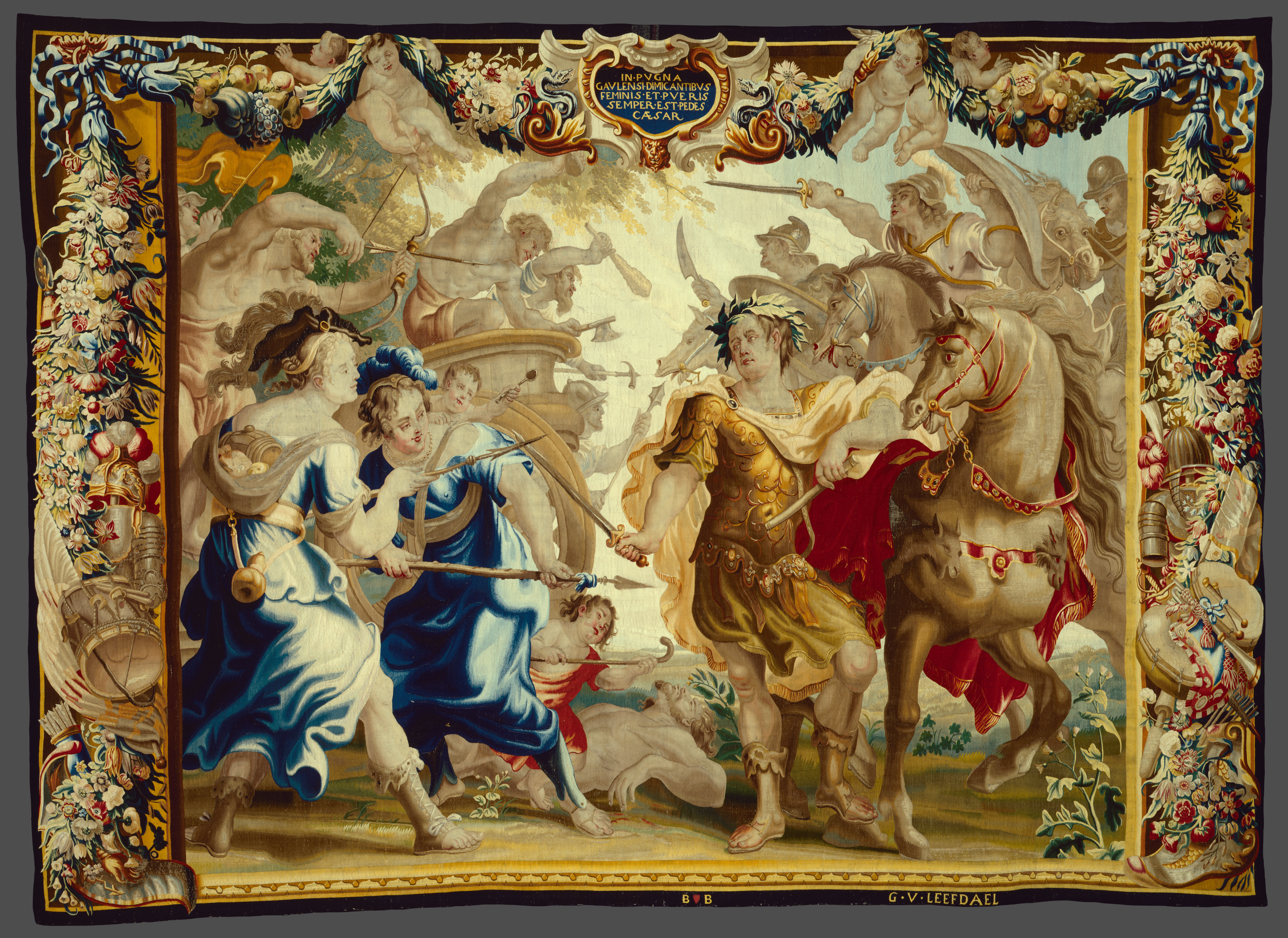 A large tapestry with an ornate border featuring four people and a horse in the foreground of a battle scene.
