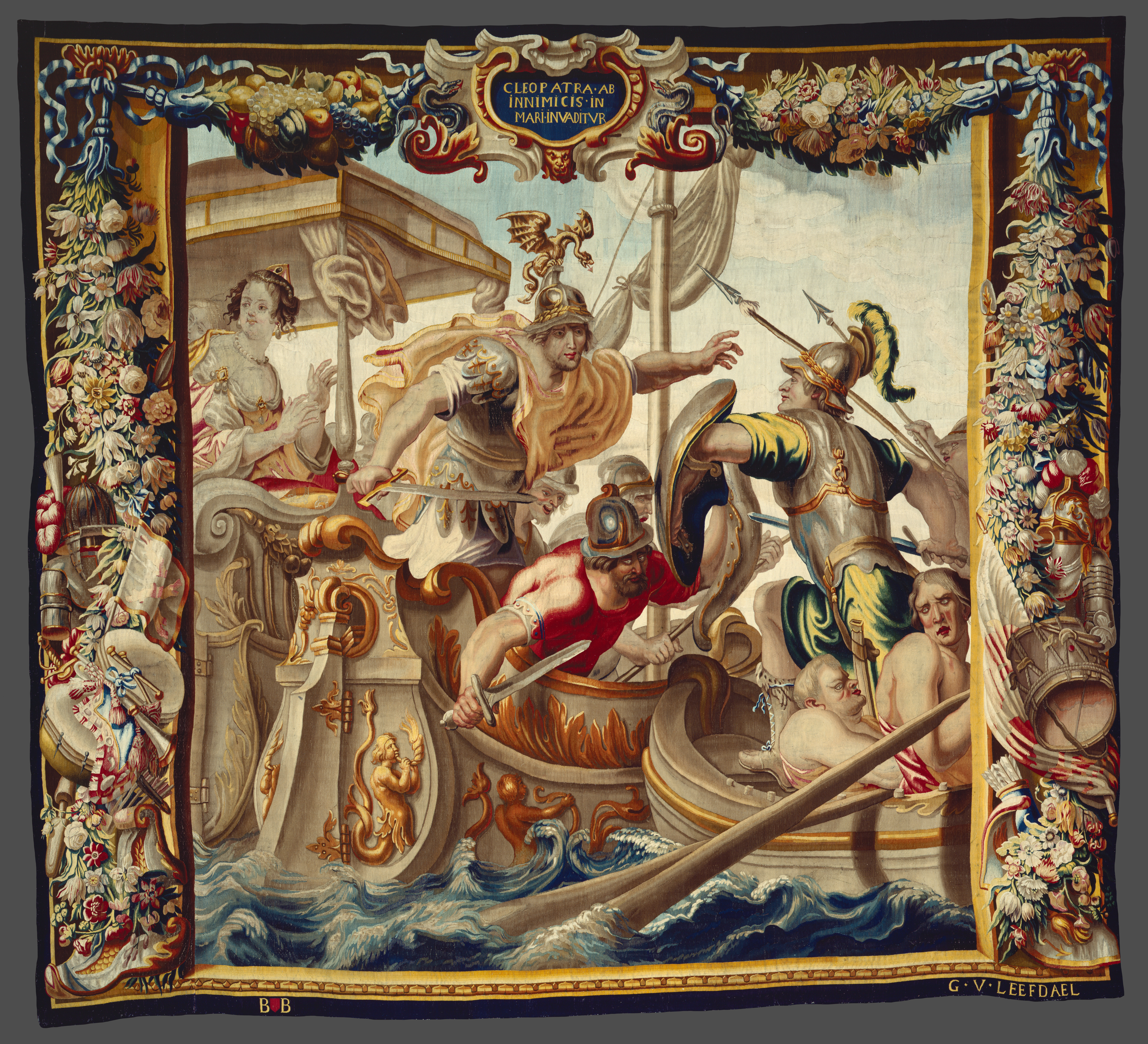 A large tapestry with an ornate border featuring battle scene across multiple boats in the water.