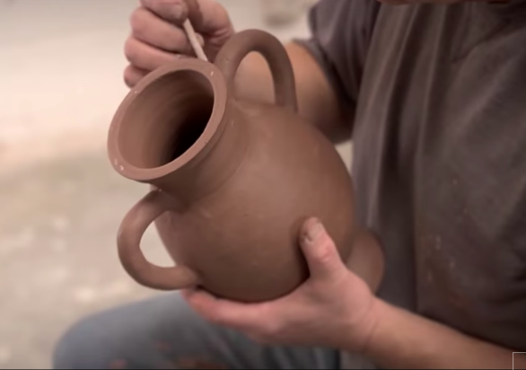 Potter making a replica of a Greek vase