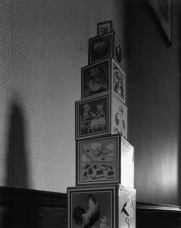 Stack of toy blocks, photographed from below, resembling a tall tower.