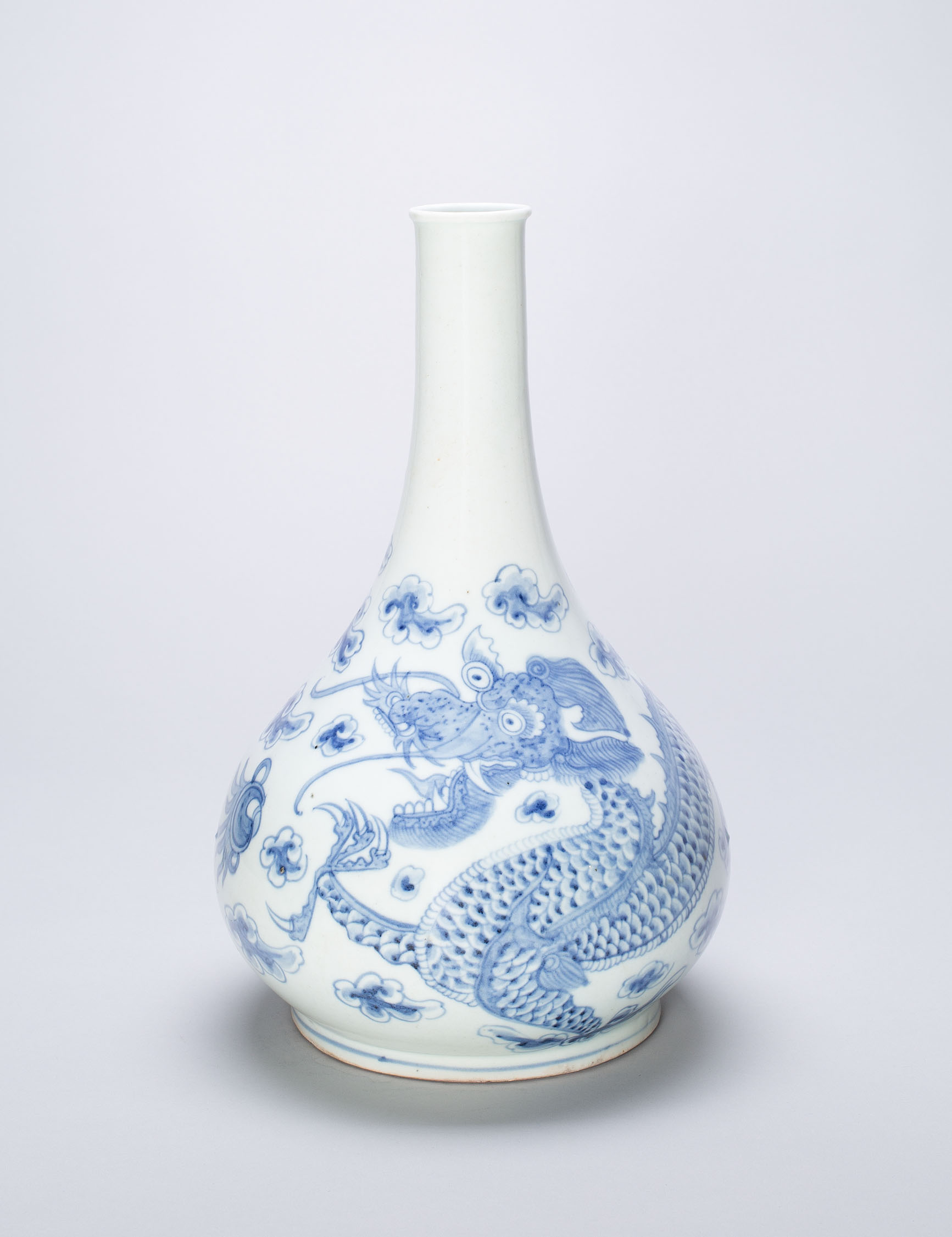 White porcelain vase with blue decorations in the form of a dragon and flowers.