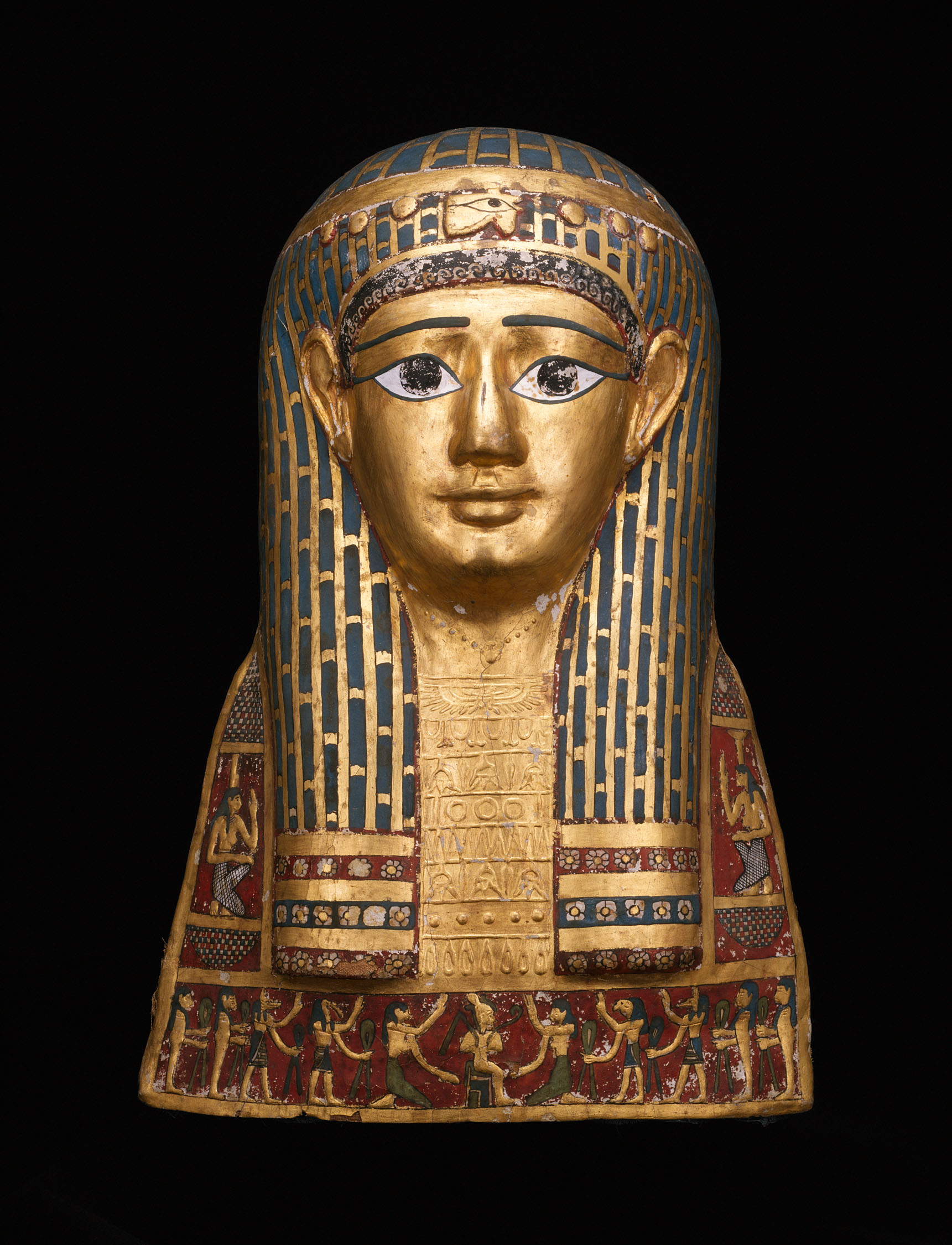 A wooden sculpture of the head and neck of a person, the skin painted gold, a geometrically decorated long wig, and many painted symbols.